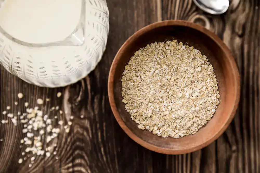 Wooden bowl filled with finely ground colloidal oats